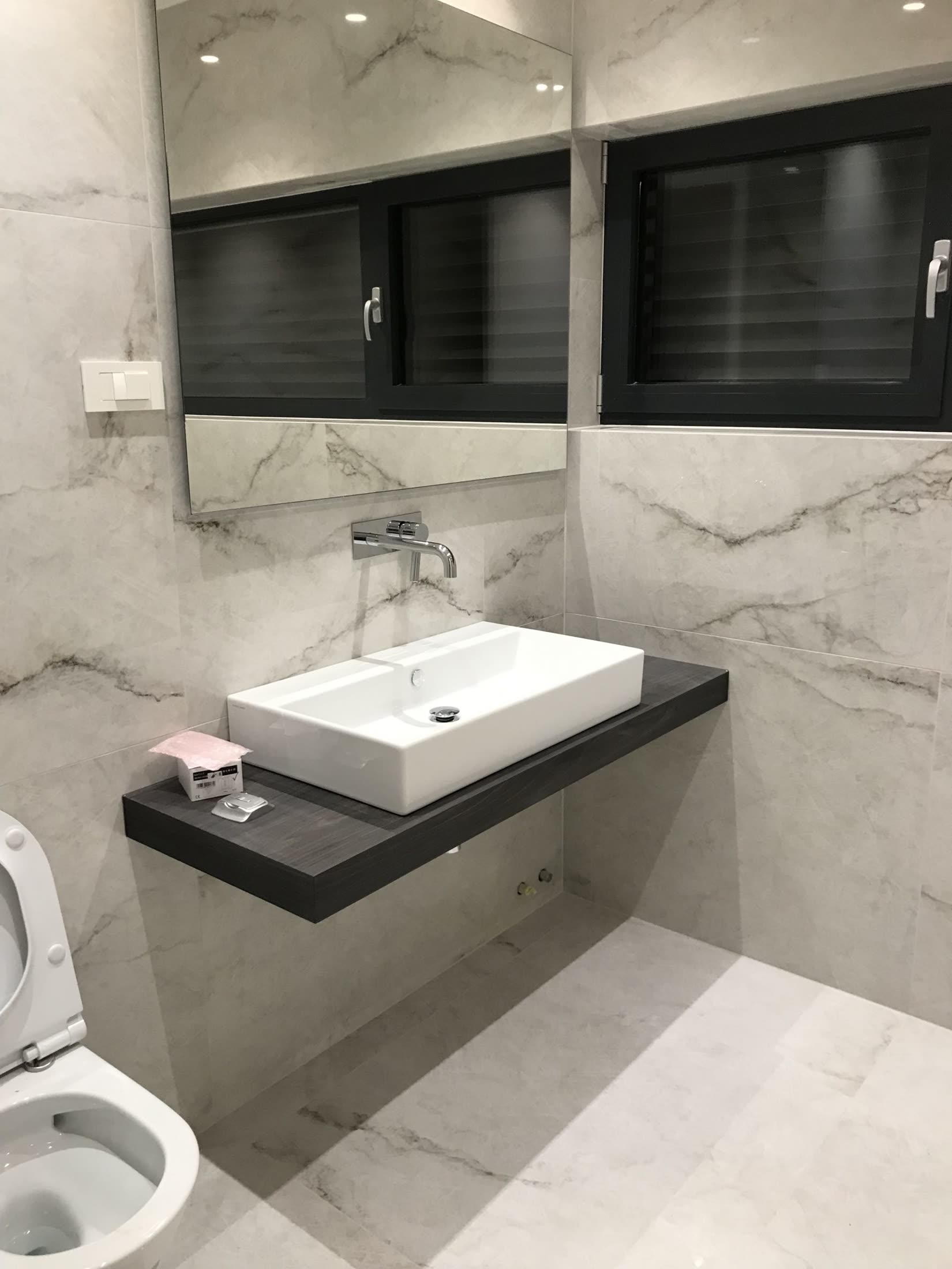 Modern bathroom with white marble tiles
